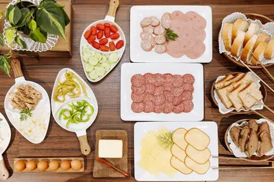 a table filled with different types of food on plates at Gostišče Krivograd in Prevalje