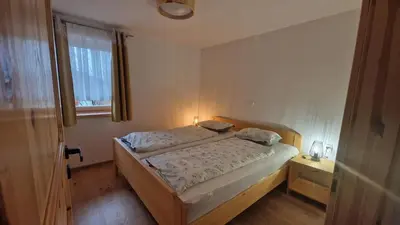 a small bedroom with a bed and a window at Tourist farm Gričnik in Resnik