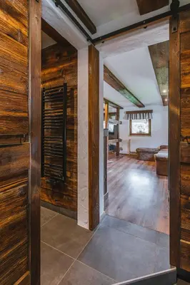 an open living room with wooden walls and wooden floors at Apartment Trentar in Kranjska Gora