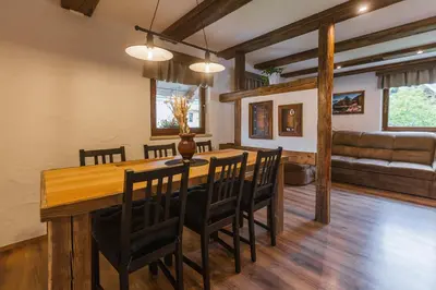 a dining room with a wooden table and chairs at Apartment Trentar in Kranjska Gora