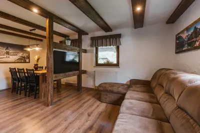 a living room with a large couch and a table at Apartment Trentar in Kranjska Gora