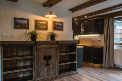 a kitchen with a wooden island with shelves at Apartment Trentar in Kranjska Gora
