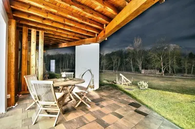a patio with a table and chairs on a patio at 7th Mill apartments in Kranj