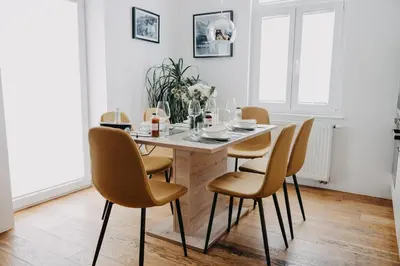 a dining room with a table and chairs at Apartments Miki's in Bled
