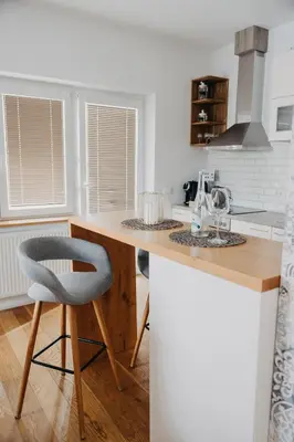 a kitchen with a counter and a chair in it at Apartments Miki's in Bled