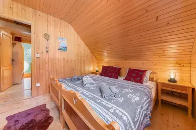 a bedroom with a bed in a wooden cabin at Chalet Trzinka - Triglav National Park in Goreljek