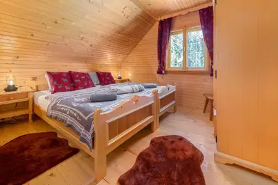 a bedroom with a bed in a log cabin at Chalet Trzinka - Triglav National Park in Goreljek