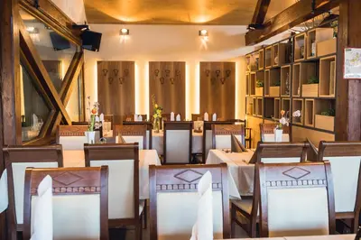 a dining room with wooden tables and chairs at Gostilna Müller in Črnomelj