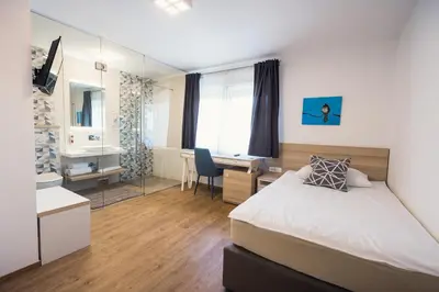 a hotel room with a bed and a desk and a desk at Gostilna Müller in Črnomelj
