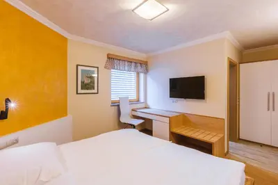 a bedroom with a bed and a desk with a computer at Apartment Ledrar in Bled