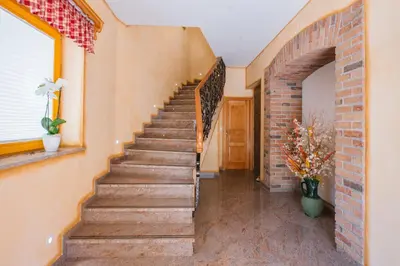a staircase in a home with a brick wall at Apartment Ledrar in Bled