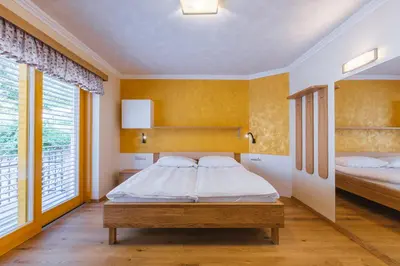 a bedroom with two beds and yellow walls at Apartment Ledrar in Bled