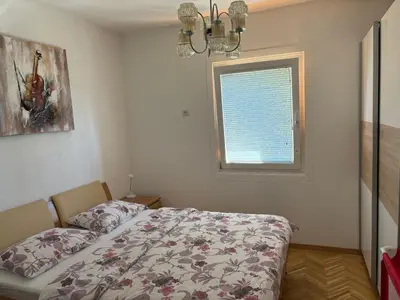 a bedroom with a bed and a window at Apartments Nina in Bled