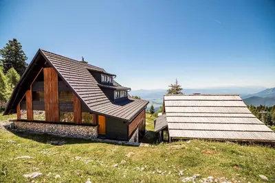 a small house on top of a hill at Apartments Zvoh, Krvavec, Ski-in, Ski-out in Cerklje na Gorenjskem