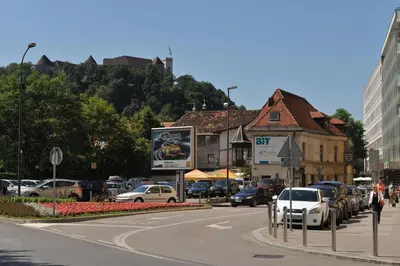 a city street with cars parked on the side of the road at Tiny central studio apartment Nika Ljubljana in Ljubljana