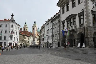 a city street with buildings and people walking around at Tiny central studio apartment Nika Ljubljana in Ljubljana