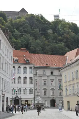 a group of buildings in a town with a mountain at Tiny central studio apartment Nika Ljubljana in Ljubljana