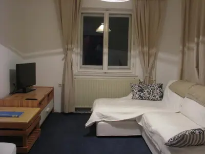 a hotel room with a couch and a window at House Cilka in Kranjska Gora