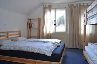 a bedroom with a bed and a window at House Cilka in Kranjska Gora