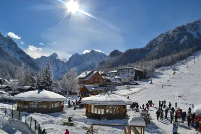 a group of people on a ski slope in the snow at House Cilka in Kranjska Gora