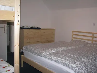 a bedroom with a bed and a wooden dresser at House Cilka in Kranjska Gora