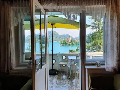 a view of a lake from a room with an umbrella at Sovica in Bled