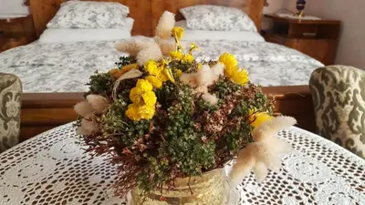 a vase filled with flowers sitting on a table at Sovica in Bled