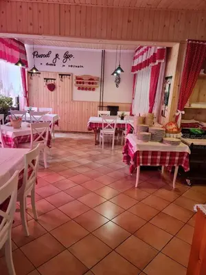a dining room with tables and chairs and pink curtains at Penzion Valerija in Zgornje Jezersko