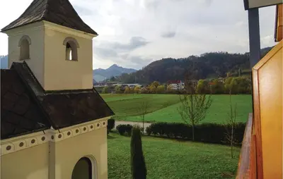 a church tower with a view of a green field at Beautiful Apartment In Lasko With Wifi in Laško