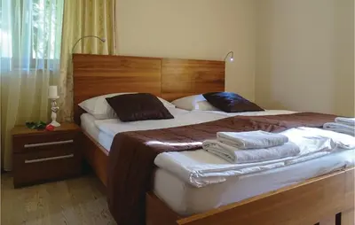 a bedroom with two beds with towels on them at Beautiful Apartment In Lasko With Wifi in Laško