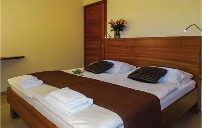 a bedroom with a large bed with towels on it at Beautiful Apartment In Lasko With Wifi in Laško