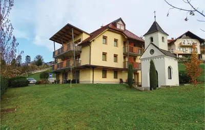 a large building with a clock tower in the yard at Beautiful Apartment In Lasko With Wifi in Laško