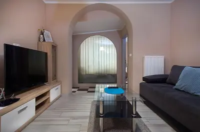 a living room with a couch and a flat screen tv at Rooms & Apartments Banjac in Maribor