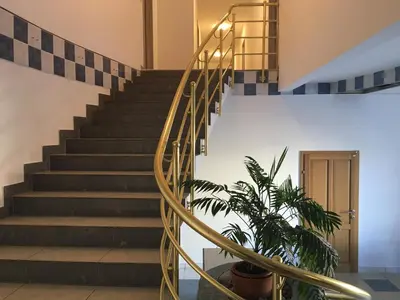 a spiral staircase in a building with a plant at Rooms & Apartments Banjac in Maribor