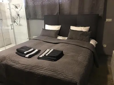 a bed with two towels and pillows on it at Rooms & Apartments Banjac in Maribor