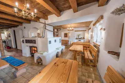 a living room with wooden tables and a fireplace at Country house Dovje in Dovje