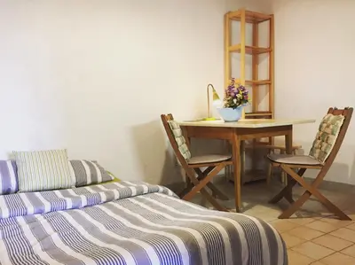 a bedroom with a table and a bed and a table and chairs at Country house Dovje in Dovje