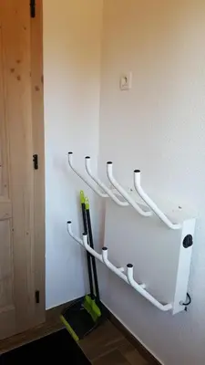 a wall with white hooks on a wall at Apartmaji Golob-Golte in Mozirje