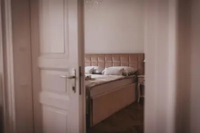 a bedroom with a bed with two pillows on it at AB Ljubljana - Prince Filip Apartment in Ljubljana