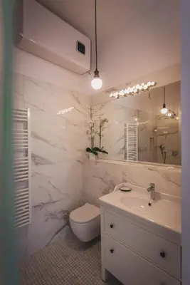 a bathroom with a sink and a toilet and a mirror at AB Ljubljana - Prince Filip Apartment in Ljubljana