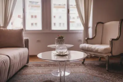 a living room with a table and two chairs at AB Ljubljana - Prince Filip Apartment in Ljubljana