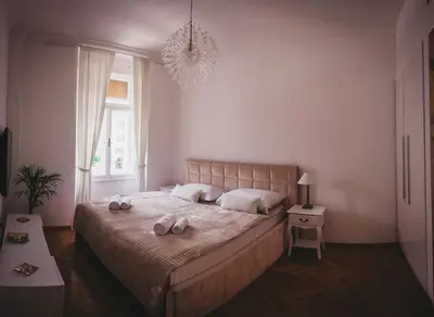 a bedroom with a bed with two towels on it at AB Ljubljana - Prince Filip Apartment in Ljubljana