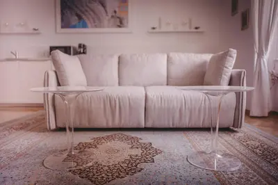a living room with a white couch and two tables at AB Ljubljana - Prince Filip Apartment in Ljubljana