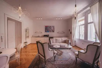 a living room with a couch and a table and chairs at AB Ljubljana - Prince Filip Apartment in Ljubljana