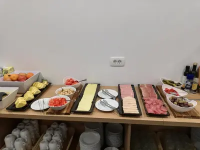 a table filled with different types of food on plates at Life Hostel Slovenia in Radovljica