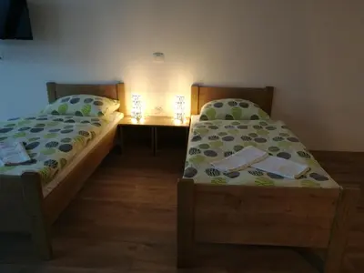 two beds sitting next to each other in a room at Life Hostel Slovenia in Radovljica