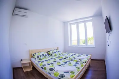 a bedroom with a bed and a window at Life Hostel Slovenia in Radovljica