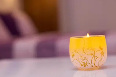 a yellow candle sitting on top of a table at MTM apartment in Bled