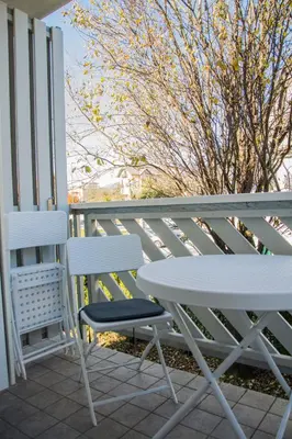 two chairs and a table on a porch at MTM apartment in Bled