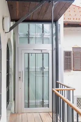 an open glass door on a building with a porch at Strict city apartments in Ljubljana